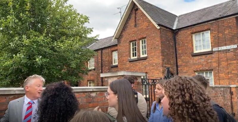 Summer School students outside the railway cottages in Crewe.